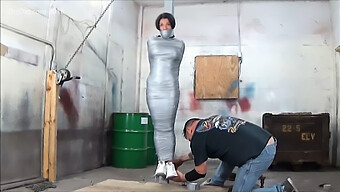 Busty Girl Restrained With Duct Tape On A Post